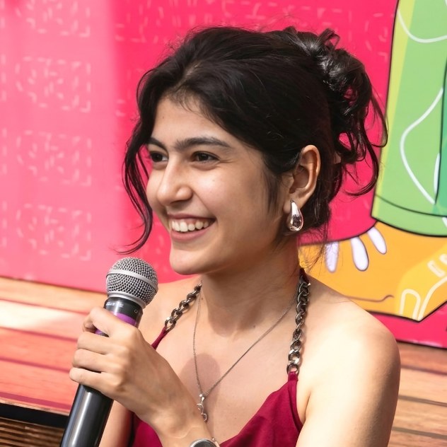 Diya Nathwani speaking into a microphone