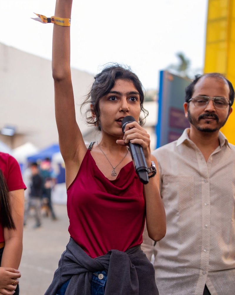 Diya speaking into a microphone at an IFP x MBP event